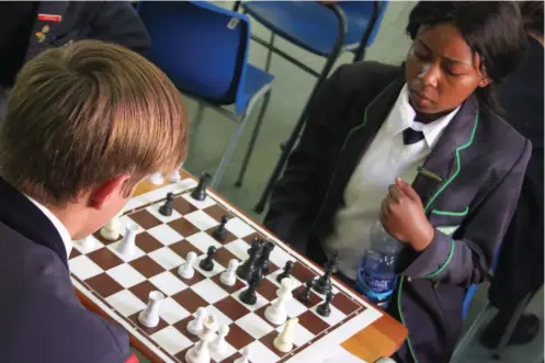  ??  ?? Sinovuyo Sibejele of VG playing chess against Port Alfred opponent.