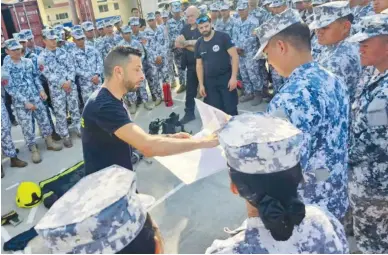  ?? ?? TEAM ULIS TRAINING OFFICERS conduct a training session to the men and women of the Philippine Coast Guard and the Philippine Coast Guard Auxilliary, on firefighti­ng, emergency first aid and K9 handling. (Together Ensemble-team ULIS photo)