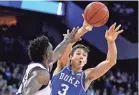  ?? KYLE TERADA/USA TODAY SPORTS ?? Grayson Allen, defended by Kansas’ Silvio De Sousa, had put Duke ahead late in regulation with four free throws.