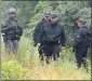  ?? MICHAEL DWYER THE ASSOCIATED PRESS ?? Police gather near the site of a standoff with a group of armed men Saturday in Wakefield, Mass.