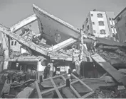  ?? MOHAMMED DAHMAN/AP ?? Palestinia­ns inspect the damage of a destroyed house Sunday after Israeli airstrikes on Khan Younis in the southern Gaza Strip. An airstrike hit a house between Khan Younis and the southern city of Rafah, killing at least seven people.