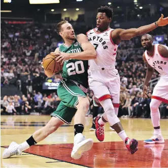  ?? FRANK GUNN/THE CANADIAN PRESS ?? Boston Celtics forward Gordon Hayward’s drive to the basket is cut off by Raptors guard Kyle Lowry at Scotiabank Arena in Toronto on Friday night.