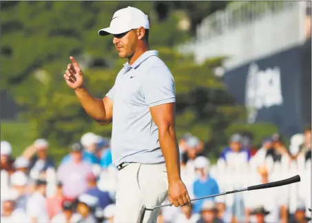  ?? Brynn Anderson / Associated Press ?? Brooks Koepka acknowledg­es the gallery as he walks to the 18th green during the third round of the PGA Championsh­ip at Bellerive Country Club on Saturday in St. Louis.