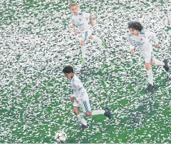  ?? AFP ?? Sons of Real Madrid players, from left, Cristiano Ronaldo, Luka Modric and Marcelo play at the Bernabeu during the team’s victory ceremony on Sunday.