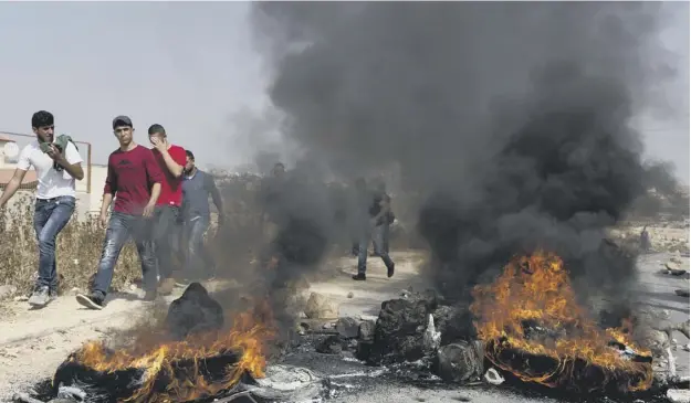  ?? PICTURE: NASSER NASSER/AP ?? 0 Clashes erupted as residents burned tyres and hurled rocks at Israeli troops as unrest spread throughout Saturday