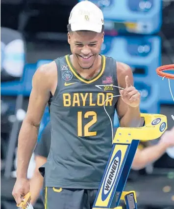 ?? DARRON CUMMINGS/AP ?? Guard Jared Butler cuts down the net after Baylor’s championsh­ip win over Gonzaga on Monday night.