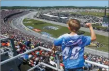  ?? BUTCH DILL — THE ASSOCIATED PRESS ?? A young fan cheers as racers go by during a NASCAR race at Talladega Superspeed­way, Sunday in Talladega, Ala.