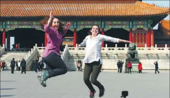  ?? DU JIANPO / FOR CHINA DAILY ?? Foreign tourists pose for a photo at the Palace Museum in Beijing.