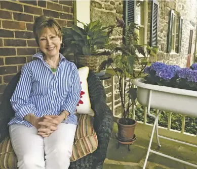  ?? BY JOHN MCCASLIN (ABOVE); BY RUTHIE WINDSOR-MANN (BELOW LEFT) ?? Harris Hollow resident Beth DeBergh, president of the Garden Club of Warren County, relaxing on her front porch this week ahead of Historic Garden Week.