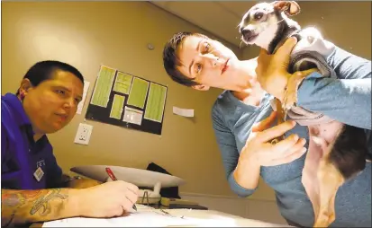  ??  ?? Above: Rochelle Ball, animal care coordinato­r, left, and Linda Sackman, director of shelter operation, check out a chihuahua mix dog in the new Travers Family Compassion and Care Center at the East Bay SPCA in Oakland on Wednesday.