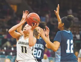  ?? John Leyba, The Denver Post ?? Evergreen’s Baylee Galan-Browne tries to score Thursday against Erika Warner (12) and Widefield during their teams’ Class 4A semifinal game at the Denver Coliseum.