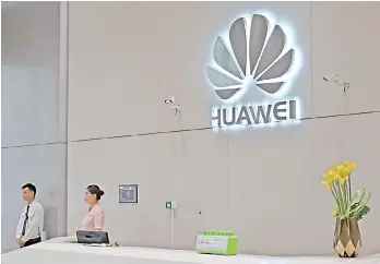  ?? — AFP photo — AFP photo ?? A company logo is displayed at a reception area at the Huawei headquarte­rs in Shenzhen, China’s Guangdong province.