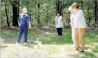  ?? Lynn Atkins/The Weekly Vista ?? Xyta Lucas, president of the Bella Vista Historical Society and a member of Questers, leads a tour of the Summit Cemetery last week as the Butterfiel­d Trails chapter of Questers Internatio­nal celebrates 40 years.