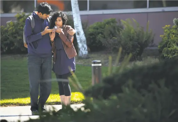  ?? Stephen Lam / Special to The Chronicle ?? A man comforts a woman near the scene of a shooting incident at YouTube headquarte­rs in San Bruno, where three people were wounded by a female shooter.