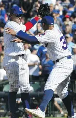  ?? DAVID BANKS/GETTY IMAGES ?? The Chicago Cubs’ Javier Baez, left, and Jon Jay celebrate their 7-4 win on Friday in Chicago.