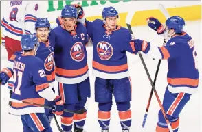  ?? Mary Altaffer / Associated Press ?? New York Islanders center Anders Lee (27) celebrates scoring a goal with his teammates during the third period of an NHL preseason game against the New York Rangers on Saturday in Bridgeport.