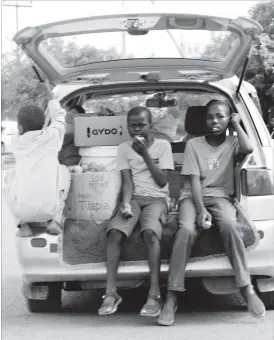  ??  ?? Children perch dangerousl­y at the back of a moving vehicle in Emakhanden­i, Bulawayo yesterday. There is a risk of them fallling off the moving vehicle, getting injured or worse