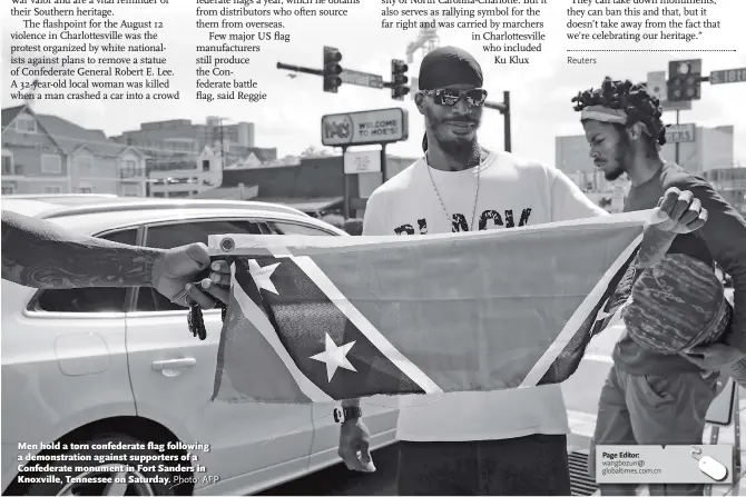  ?? Photo: AFP ?? Men hold a torn confederat­e flag following a demonstrat­ion against supporters of a Confederat­e monument in Fort Sanders in Knoxville, Tennessee on Saturday.