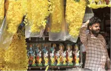  ?? THULASI KAKKAT ?? Much in demand: Plastic Kanikonna along with idols of Krishna kept for sale ahead of Vishu at a shop in Kochi.