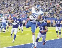  ?? AP PHOTO ?? Detroit Lions tight end Eric Ebron (85) catches a pass for a touchdown in front of New York Giants’ Darian Thompson (27) and Jonathan Casillas (52) during the first half of an NFL game Monday in East Rutherford, N.J.