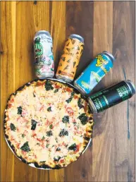  ?? Contribute­d Photo / Nolo ?? Beer from Erector Brewing surrounds a pizza at Nolo, a new restaurant on State Street. Justin Maturo, a partner at Nolo and owner of Erector Brewing also designs the beer labels.