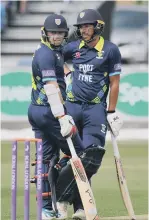  ??  ?? Michael Richardson bats on his way to a century before discussing tactics (right) with skipper Tom Latham