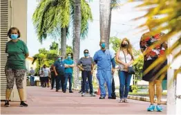  ?? EVA MARIE UZCATEGUI AFP VIA GETTY IMAGES ?? Voters wait to cast their ballots early at John F. Kennedy Public Library in Hialeah, Fla., on Monday, the first day of early voting in the state.