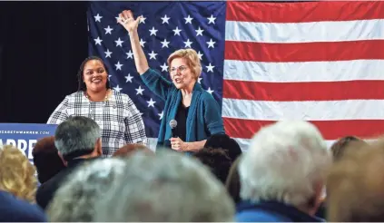  ??  ?? Democratic 2020 presidenti­al hopeful Sen. Elizabeth Warren waves to supporters as Shelby County Commission­er Tami Sawyer, left, looks on during a campaign stop at Douglass High on Sunday afternoon. MARK WEBER/THE COMMERCIAL APPEAL