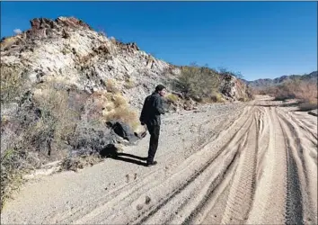  ?? Photograph­s by Irfan Khan Los Angeles Times ?? CONSERVATI­ONIST Tom Egan of Defenders of Wildlife walks along a wash at Chuckwalla Bench, a stretch of California desert labeled a “critical environmen­tal concern” by the Bureau of Land Management.