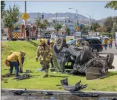  ?? Bobby Block/The Signal ?? Los Angeles County Fire Department personnel extract one patient from an SUV that overturned as a result of a traffic collision at the intersecti­on of Lyons Avenue and Orchard Village Road on Tuesday.