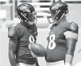  ?? WILFREDO LEE/AP ?? Ravens quarterbac­k Lamar Jackson, left, talks to then-teammate Matt Skura before a game against the Dolphins in 2019.