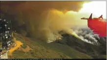  ?? COURTESY OF ALERTWILDF­IRE — UC SAN DIEGO ?? An ALERTWildf­ire camera from Santiago Peak in Orange County captures a CAL FIRE jet dropping firesuppre­ssing material in 2018.