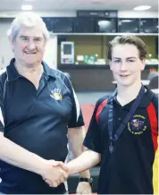  ??  ?? EDFL board chair Roger Gwynne congratula­tes Ian Cooper medallist, Bailey Stephens of Longwarry.