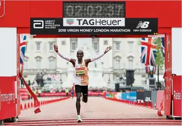  ??  ?? On or off: Kenya’s eliud Kipchoge celebrates winning the men’s race and setting a new course record in the London Marathon last year. — reuters