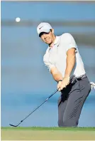  ??  ?? Flight controller: Rory Mcilroy chips on to the 11th green at Bay Hill yesterday