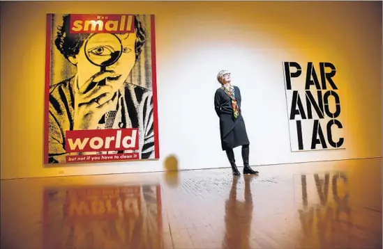  ?? Jay L. Clendenin Los Angeles Times ?? HELEN MOLESWORTH with Barbara Kruger’s “Untitled (It’s a Small World but Not if You Have to Clean It),” left, and an untitled Christophe­r Wool piece.