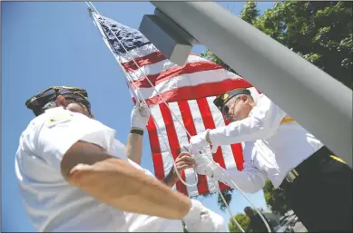  ?? NEWS-SENTINEL PHOTOGRAPH­S BY BEA AHBECK ?? American Legion Post 22’s Michael Bennett and Bill Selling raise the permanent flag as the city dedicates the new flagpole at Legion Park in Lodi on Flag Day on Friday.