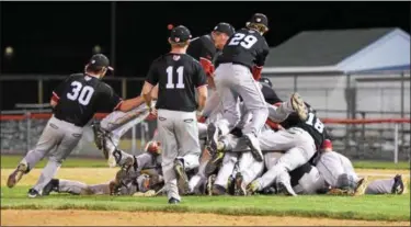  ?? AUSTIN HERTZOG - DIGITAL FIRST MEDIA ?? The Boyertown baseball team piles on to one another after winning the PAC championsh­ip with a 7-0 win over Phoenixvil­le Friday.