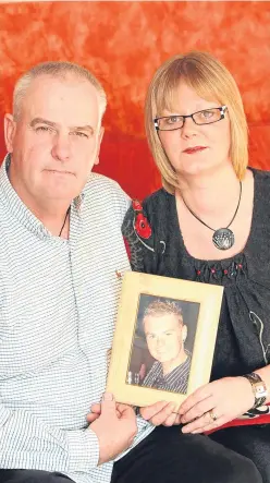  ??  ?? Malcolm and Jane Campbell with a picture of their son, Malcolm, who died at Pike River in 2010.