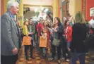  ?? MICHELLE GUTIERREZ/THE REGISTER ?? Supporters of Area Education Agencies wait in the hallway as lawmakers leave the public hearing in which Iowans gave their thoughts on the House version of a bill to overhaul the state’s AEAs on Feb. 21 at State Capitol.