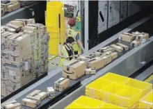  ?? THE ASSOCIATED PRESS FILE PHOTO ?? Packages move in the Amazon fulfilment centre in Sacramento, Calif.