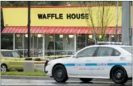  ?? THE ASSOCIATED PRESS ?? A police car sits in front of a Waffle House restaurant Sunday in Nashville, Tenn. At least four people died after a gunman opened fire at the restaurant early Sunday.