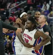  ?? PHOTOS BY CARLOS OSORIO — THE ASSOCIATED PRESS ?? Pistons center Isaiah Stewart is held back after a foul during the second half against the Los Angeles Lakers Sunday in Detroit.