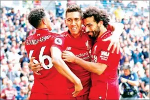  ?? AFP ?? Liverpool midfielder Roberto Firmino (centre) celebrates with teammates after scoring their second against Tottenham Hotspur and Liverpoola­t Wembley on Saturday.