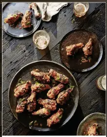  ?? CONTRIBUTE­D BY JAMES RANSOM ?? After grilling over a hot fire, toss wings in a Cholula butter sauce.