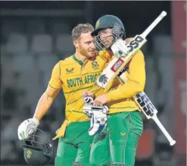  ?? AJAY AGGARWAL/HT PHOTO ?? South African Rassie van der Dussen (right) and David Miller celebrate after winning the first T20I against India.