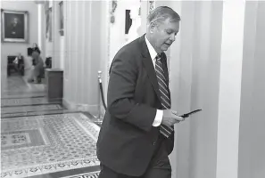  ?? AP Photo/J. Scott Applewhite ?? ■ Sen. Lindsey Graham, R-S.C., a member of the Senate Armed Services Committee, rushes to the office of Senate Majority Leader Mitch McConnell, R-Ky., at day’s end Wednesday on Capitol Hill in Washington. Amid the news that President Donald Trump is pulling all 2,000 U.S. troops out of Syria, Graham said he was “blindsided” by the report and called the decision “a disaster in the making.”