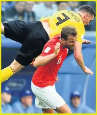  ??  ?? OVER THE TOP: Kane gets clobbered by Vermaelen