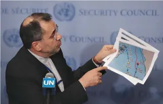  ?? REUTERS ?? IRANIAN AMBASSADOR to the United Nations Majid Takht-Ravanchi shows maps of airspace to the media outside Security Council chambers at the UN headquarte­rs in New York in this June 24 photo.