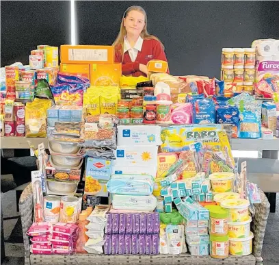  ?? Photo / Supplied ?? Cornerston­e Christian School student Charli Weel, 11, with the groceries she collected for Just Zilch.